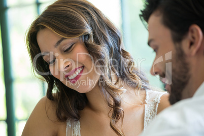 Smiling woman dating with man in restaurant