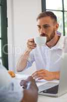 Businessman drinking coffee in restaurant