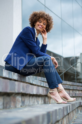 Smiling businesswoman sitting in the premises