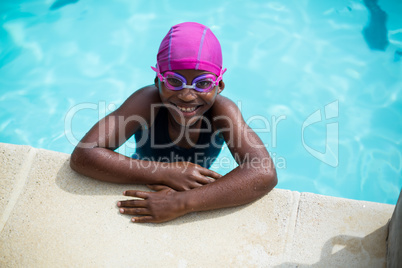 Little girl leaning at poolside