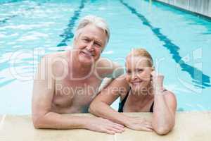 Couple leaning at poolside