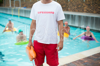 Mid section of male lifeguard at poolside