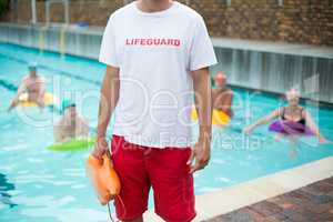 Mid section of male lifeguard at poolside