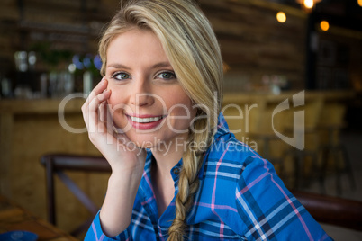 Smiling woman with blond hair in coffee shop