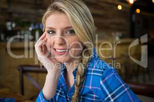 Smiling woman with blond hair in coffee shop