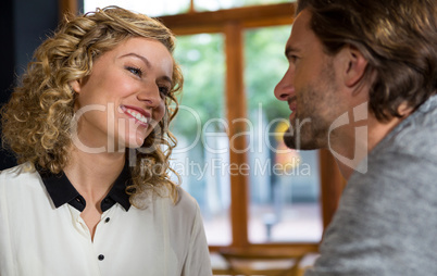 Woman talking with man in coffee shop