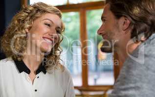 Woman talking with man in coffee shop
