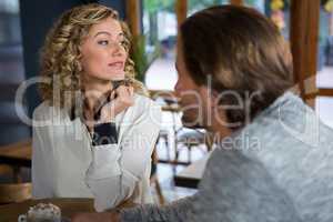 Woman with man sitting at table in coffee shop