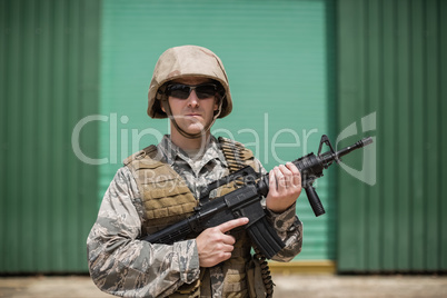 Military soldier standing with a rifle