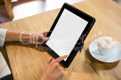 Woman using digital tablet with blank screen in cafe