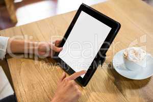 Woman using digital tablet with blank screen in cafe
