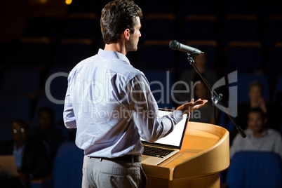 Male business executive giving a speech