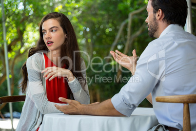 Couple having relationship difficulties at outdoor restaurant