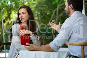 Couple having relationship difficulties at outdoor restaurant