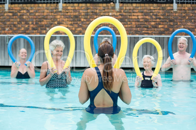 Trainer demonstrating use of pool noodle