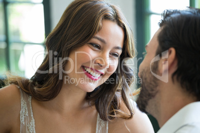 Smiling woman looking at man in restaurant