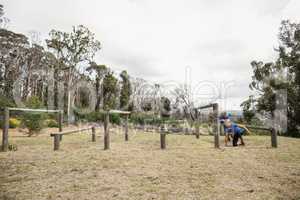 People passing through hurdles during obstacle course