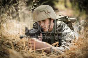 Military soldier aiming with a rifle