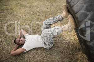 Determined military soldiers exercising with tyre