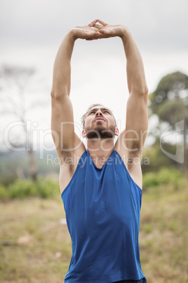 Fit man performing stretching exercise