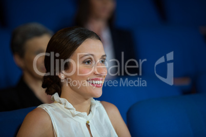 Female business executive listening to speech