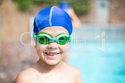 Little boy wearing swimming goggle and cap
