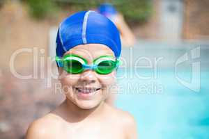 Little boy wearing swimming goggle and cap