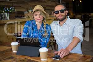 Portrait of beautiful couple sitting at table in coffee shop