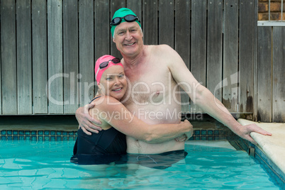 Mature couple embracing in swimming pool