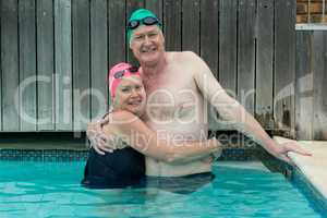 Mature couple embracing in swimming pool
