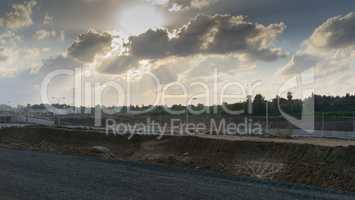 Wide angle shot of dramatic sunset with flare and godrays near Herzliya Pituah district