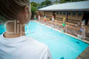 Female instructor standing at poolside