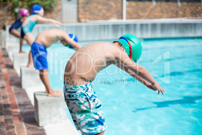 Little swimmers preparing at poolside