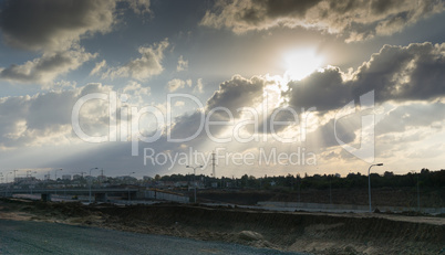 Wide angle shot of dramatic sunset with flare and godrays near Herzliya Pituah district