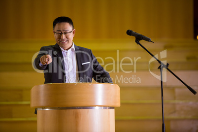 Business executive pointing while giving a speech