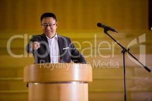 Business executive pointing while giving a speech