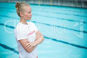 Female lifeguard standing at poolside