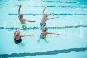 Senior swimmers exercising in swimming pool