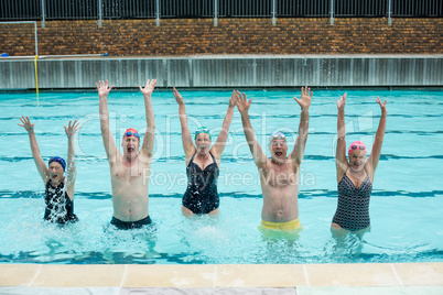 Carefree senior swimmers enjoying in pool