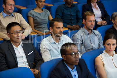 Business executives listening to speech