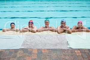 Senior swimmers leaning on poolside