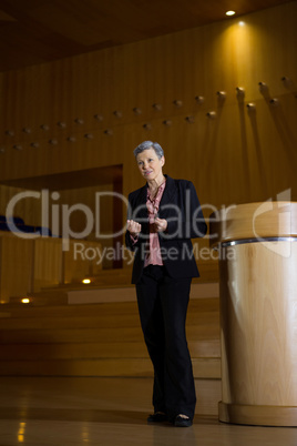 Female business executive gesturing while giving a speech