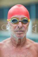 Shirtless senior swimmer wearing goggles
