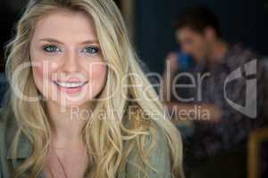 Beautiful young woman with blond hair in coffee shop