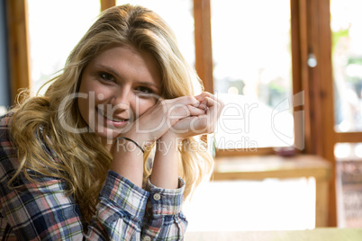 Beautiful young woman smiling in coffee house