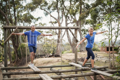 Fit man and woman during obstacle course training