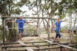 Fit man and woman during obstacle course training