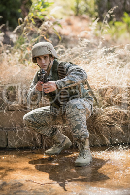 Military soldier aiming with a rifle
