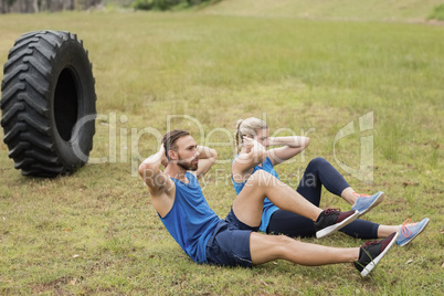 Fit people performing crunches exercise