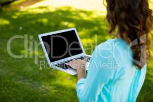 Woman using laptop in park